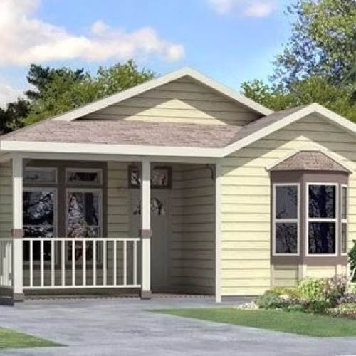 A small, charming house with a light yellow exterior, a front porch, and large windows surrounded by greenery. The setting features a clear sky and a well-maintained lawn.